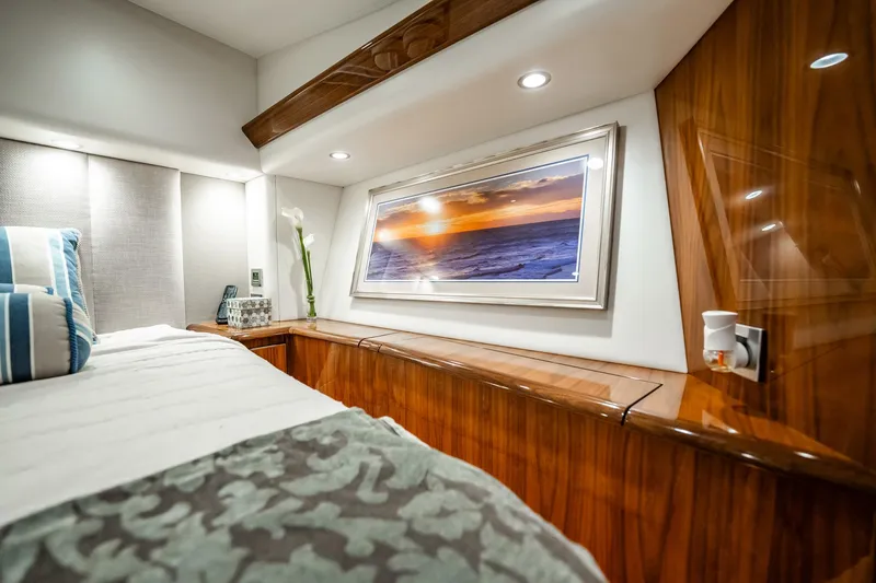 Lori A Yacht Photos Pics Luxurious 2021 Viking 54 Convertible yacht bedroom with elegant wood finish and ocean artwork.