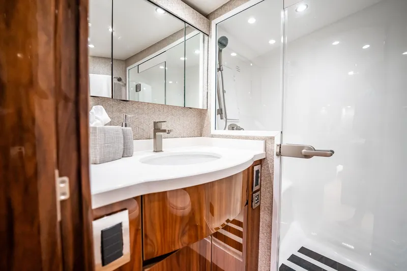 Lori A Yacht Photos Pics Luxurious bathroom in 2021 Viking 54 Convertible yacht with modern fixtures and elegant design.