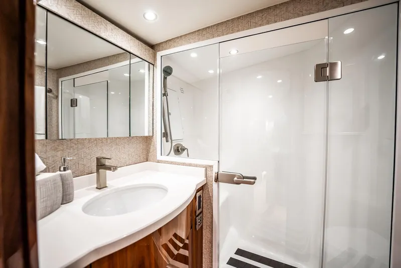 Lori A Yacht Photos Pics Luxurious bathroom in 2021 Viking 54 Convertible yacht with modern fixtures and spacious shower.
