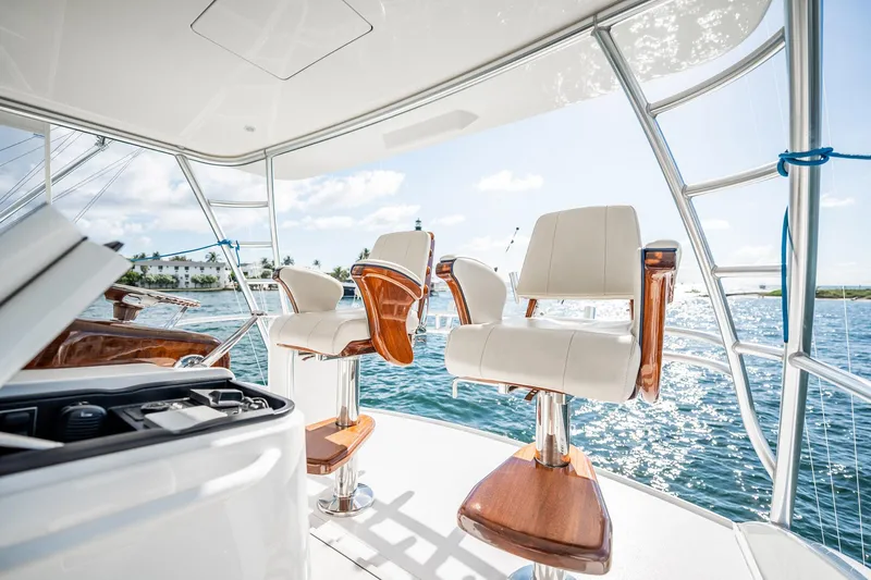 Lori A Yacht Photos Pics Luxurious seating on 2021 Viking 54 Convertible yacht, overlooking serene ocean waters.