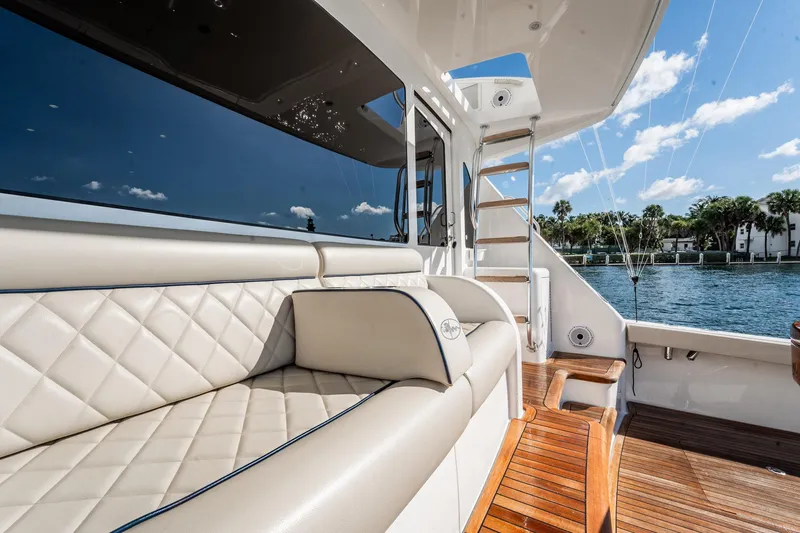 Lori A Yacht Photos Pics Luxurious seating on 2021 Viking 54 Convertible yacht, with scenic waterfront view.