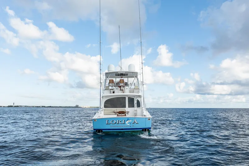 Lori A Yacht Photos Pics 2021 Viking 54 Convertible yacht on open sea under blue sky.