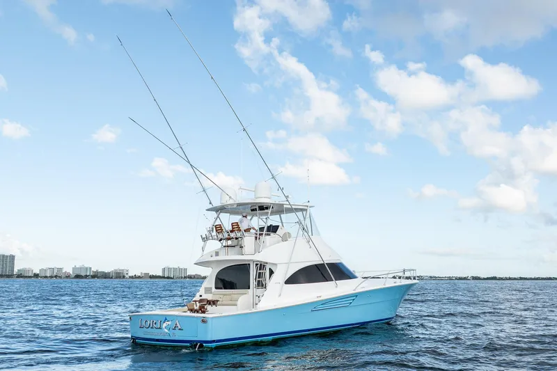 Lori A Yacht Photos Pics 2021 Viking 54 Convertible yacht on open water under a clear blue sky.