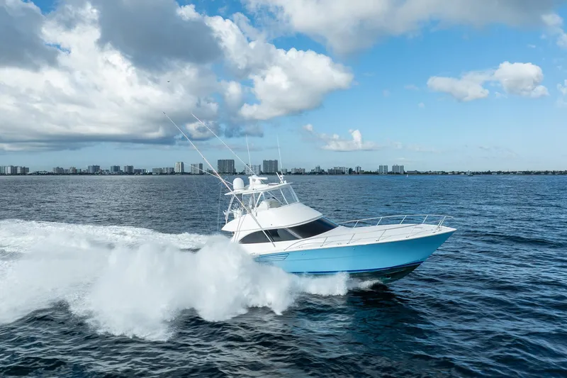 Lori A Yacht Photos Pics 2021 Viking 54 Convertible yacht cruising on open water under a partly cloudy sky.