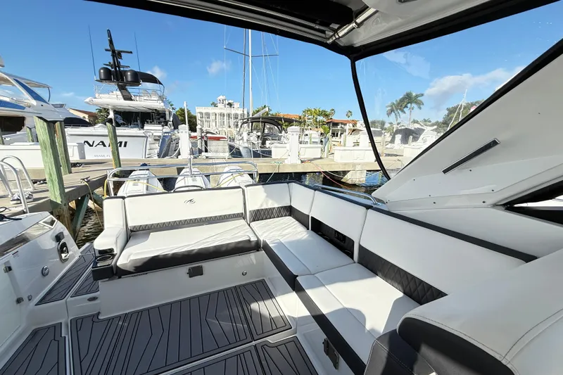  Yacht Photos Pics 2022 Monterey 385SS Super Sport boat interior at marina, featuring sleek seating and modern design.