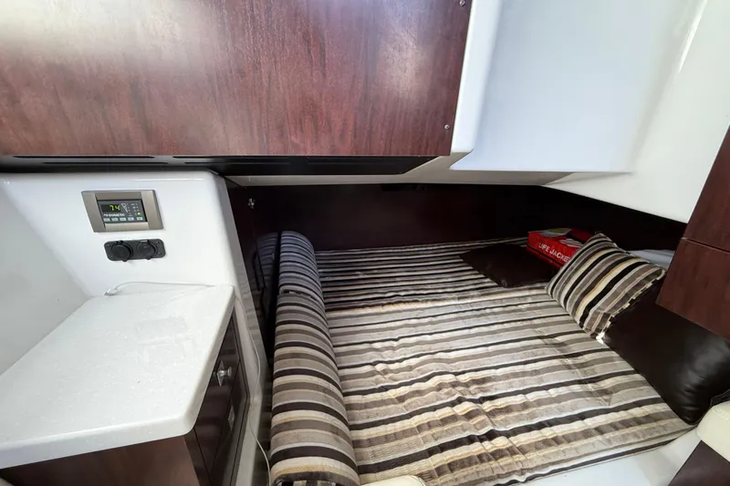  Yacht Photos Pics 2022 Monterey 385SS Super Sport cabin with striped bedding and modern interior.