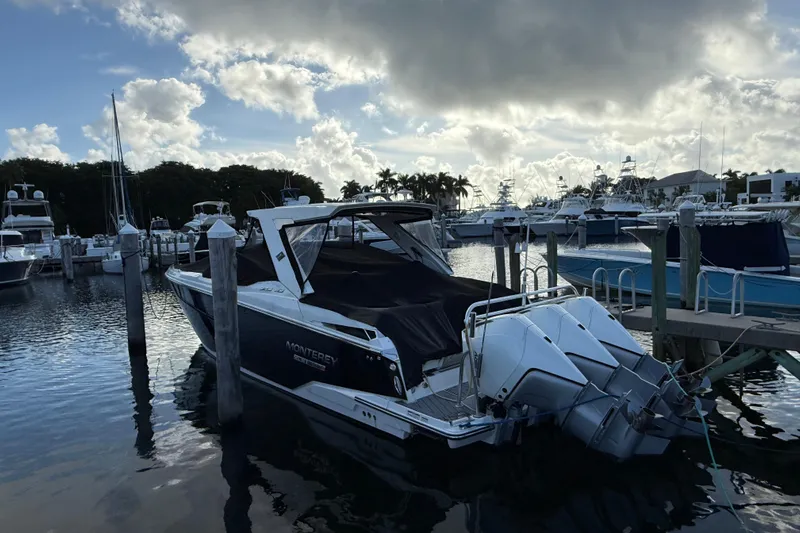  Yacht Photos Pics 2022 Monterey 385SS Super Sport boat docked at marina under cloudy sky.