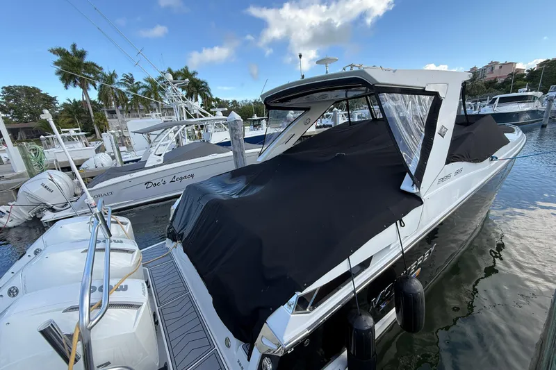  Yacht Photos Pics 2022 Monterey 385SS Super Sport boat docked at marina with cover, surrounded by other boats.