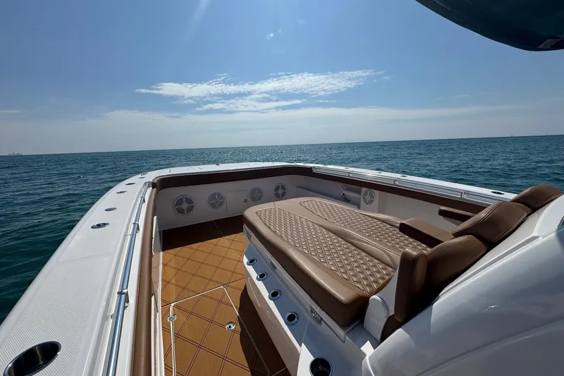  Yacht Photos Pics Luxurious 2024 Invincible 46 Catamaran with elegant seating, cruising on open sea.