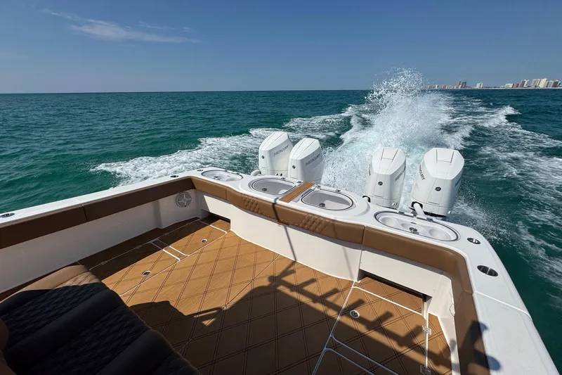  Yacht Photos Pics 2024 Invincible 46 Catamaran cruising on open sea with powerful outboard engines.