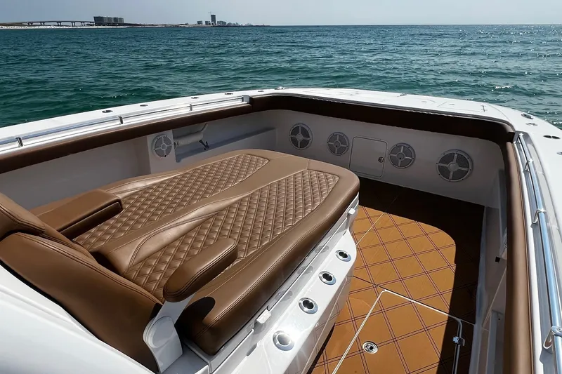  Yacht Photos Pics Luxurious seating on 2024 Invincible 46 Catamaran, featuring elegant brown upholstery and ocean view.