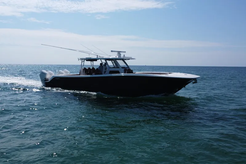  Yacht Photos Pics 2024 Invincible 46 Catamaran cruising on open water under clear skies.