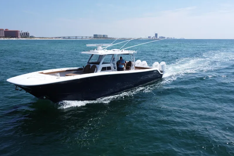  Yacht Photos Pics 2024 Invincible 46 Catamaran cruising on open water, showcasing sleek design and performance.