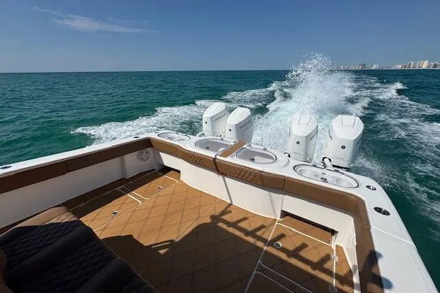  Yacht Photos Pics 2024 Invincible 46 Catamaran cruising on open sea with powerful engines.