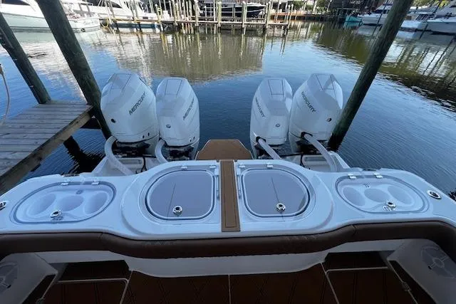  Yacht Photos Pics 2024 Invincible 46 Catamaran with four Mercury outboard engines docked at marina.