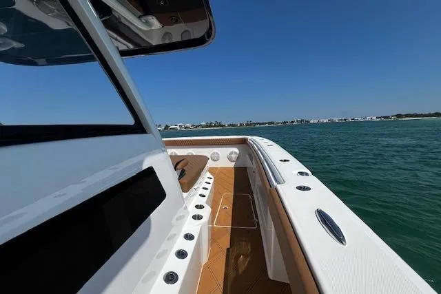  Yacht Photos Pics 2024 Invincible 46 Catamaran on water, showcasing sleek deck design and ocean view.