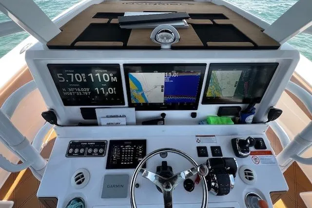  Yacht Photos Pics 2024 Invincible 46 Catamaran helm with navigation screens and controls.