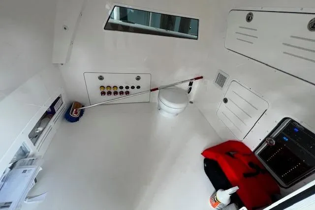  Yacht Photos Pics 2024 Invincible 46 Catamaran interior with storage, controls, and marine toilet.
