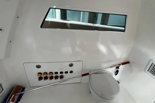  Yacht Photos Pics 2024 Invincible 46 Catamaran interior with control panel and marine toilet.