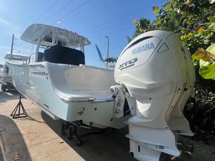  Yacht Photos Pics 2024 Sportsman 352 Open boat with Yamaha XTO engine, docked outdoors.