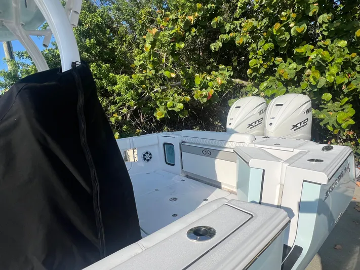  Yacht Photos Pics 2024 Sportsman 352 Open boat with twin Yamaha engines, surrounded by lush greenery.