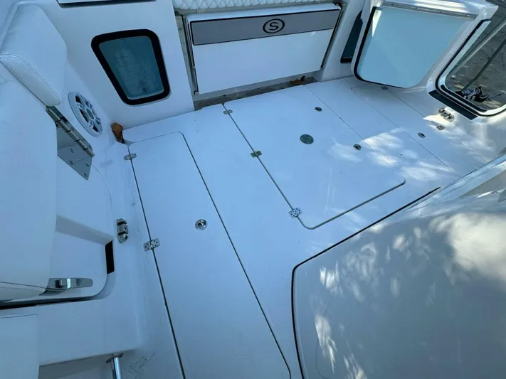  Yacht Photos Pics 2024 Sportsman 352 Open boat deck with storage compartments and seating.
