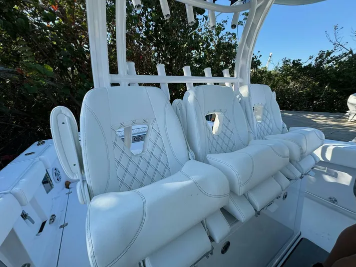  Yacht Photos Pics 2024 Sportsman 352 Open boat with luxurious white seating and sleek design.