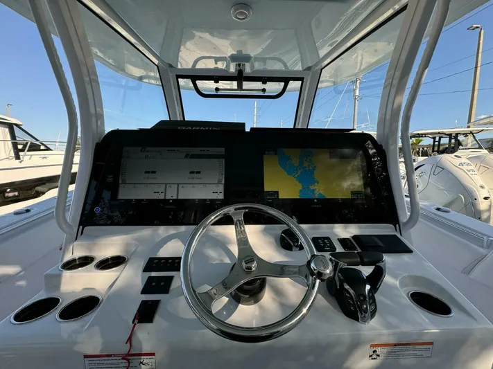  Yacht Photos Pics 2024 Sportsman 352 Open boat dashboard with Garmin navigation system and steering wheel.