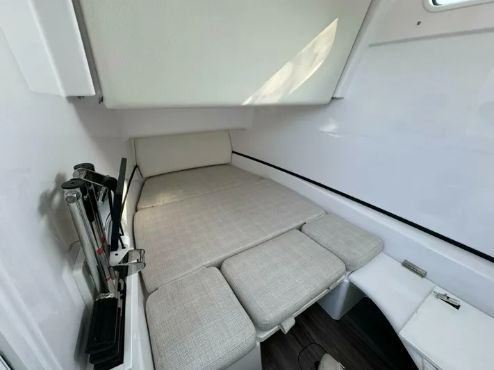  Yacht Photos Pics 2024 Sportsman 352 Open cabin interior with cushioned bed and sleek design.