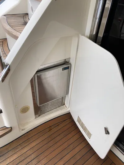Dreamer Yacht Photos Pics 2005 Azimut 80 Carat yacht interior with open storage compartment and wooden flooring.