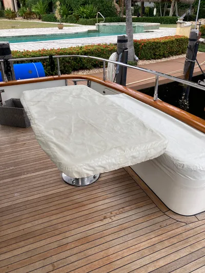 Dreamer Yacht Photos Pics 2005 Azimut 80 Carat yacht deck with covered table and seating area.