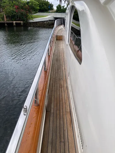 Dreamer Yacht Photos Pics Side deck of a 2005 Azimut 80 Carat yacht with wooden flooring.