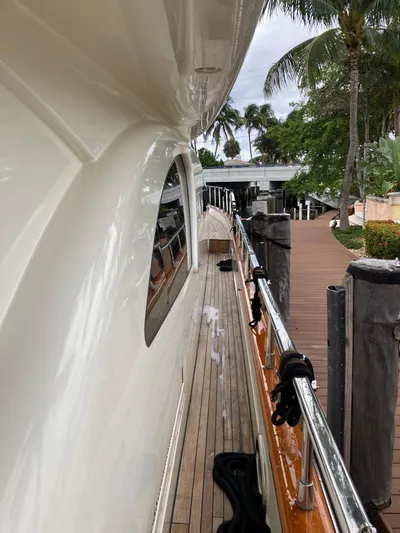 Dreamer Yacht Photos Pics Side view of 2005 Azimut 80 Carat yacht docked near tropical foliage.