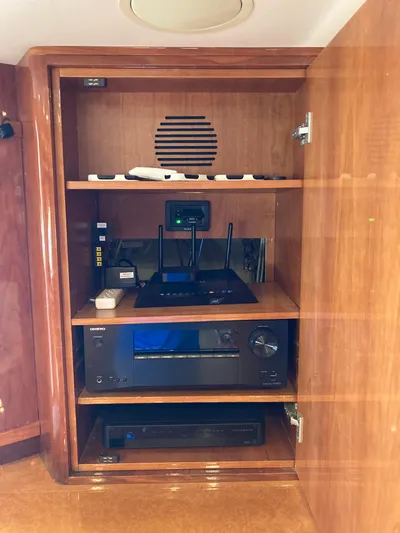 Dreamer Yacht Photos Pics Wooden cabinet with electronic equipment on a 2005 Azimut 80 Carat yacht.