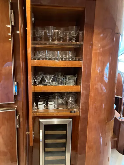 Dreamer Yacht Photos Pics Luxury yacht Azimut 80 Carat 2005 interior with glassware cabinet and wine cooler.