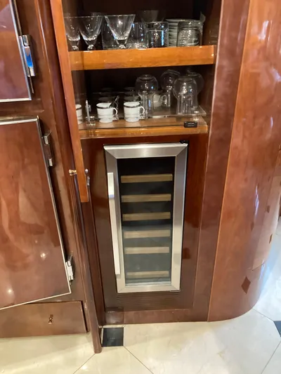 Dreamer Yacht Photos Pics Luxury yacht interior with glassware cabinet and wine cooler, Azimut 80 Carat 2005 model.