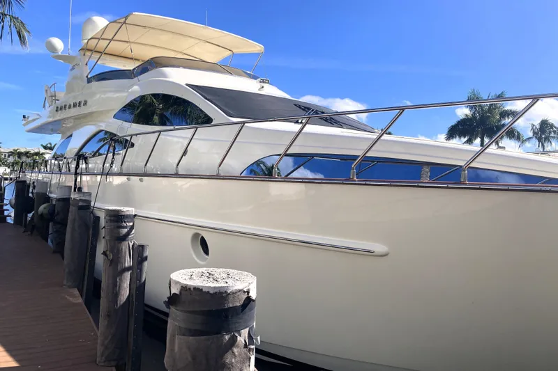 Dreamer Yacht Photos Pics Luxury 2005 Azimut 80 Carat yacht docked under clear blue sky.
