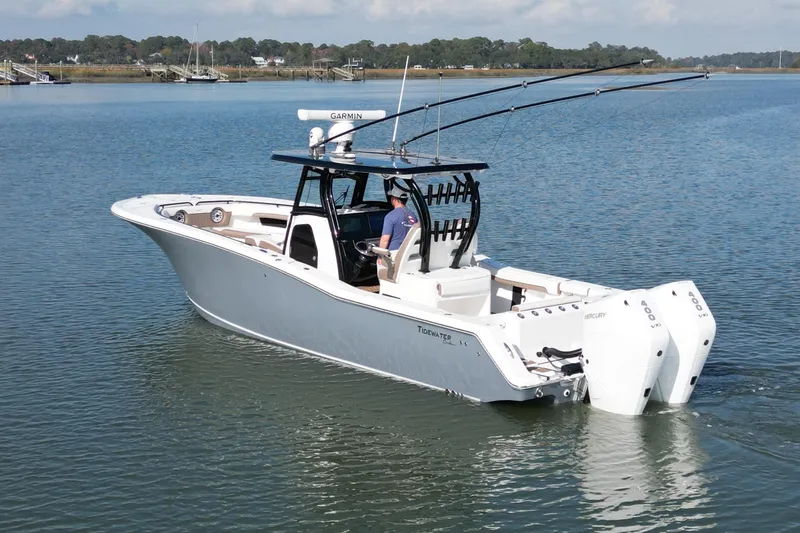  Yacht Photos Pics 2025 Tidewater 320 CC Adventure boat with dual engines on calm water.