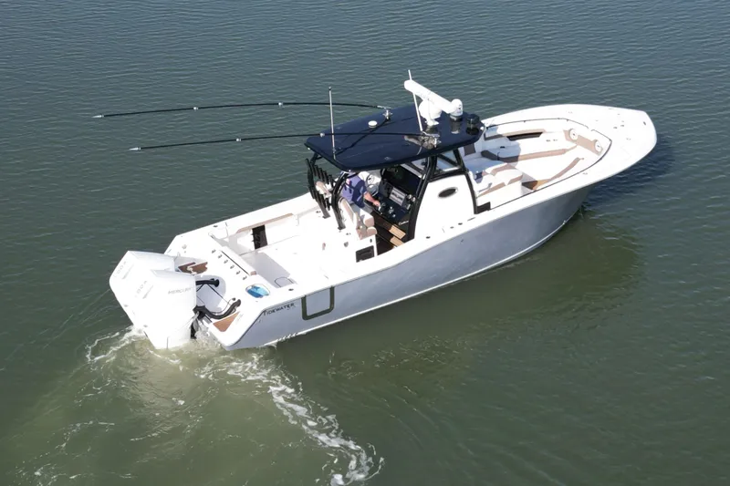  Yacht Photos Pics 2025 Tidewater 320 CC Adventure boat cruising on calm water.