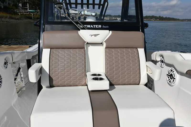  Yacht Photos Pics 2025 Tidewater 320 CC Adventure boat seating with cup holders, featuring elegant brown and white upholstery.