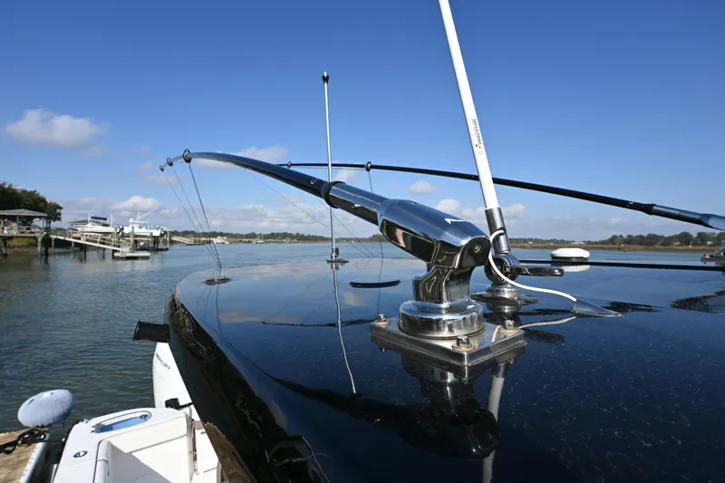  Yacht Photos Pics 2025 Tidewater 320 CC Adventure boat with fishing rod holders on a sunny day.