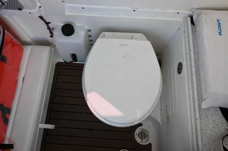  Yacht Photos Pics 2025 Tidewater 320 CC Adventure boat toilet area with wooden flooring.