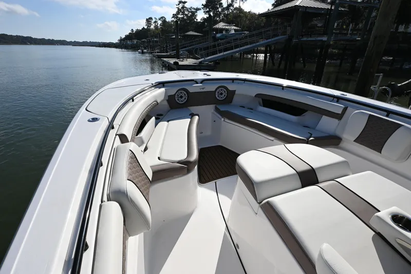  Yacht Photos Pics 2025 Tidewater 320 CC Adventure boat interior with luxurious seating and waterfront view.