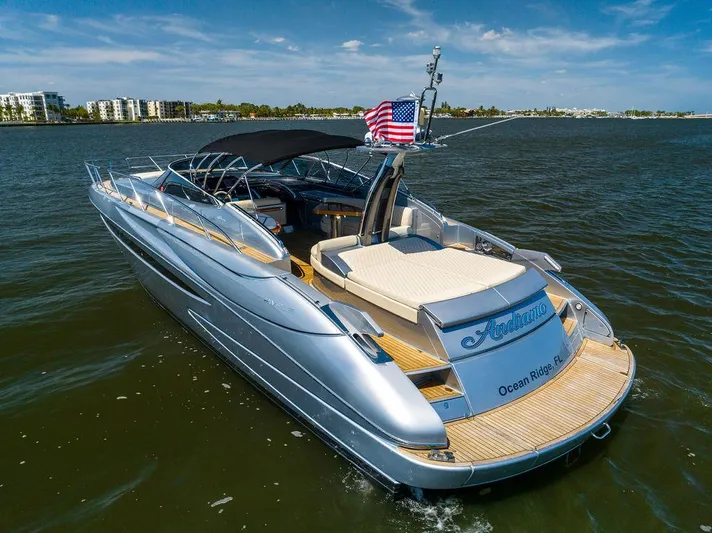 Andiamo Yacht Photos Pics 2014 Riva 52 LE yacht on water, American flag, sunny day, luxury boating.