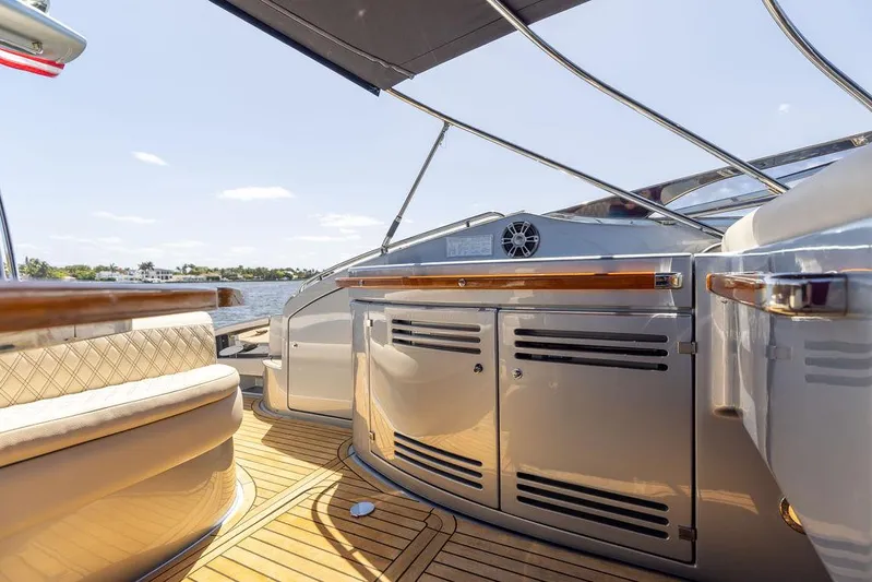 Andiamo Yacht Photos Pics Luxurious 2014 Riva 52 LE yacht interior with sleek cabinetry and wooden flooring.