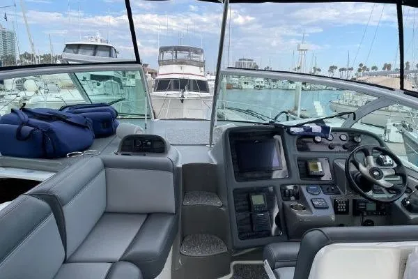  Yacht Photos Pics 2005 Cruisers 420 yacht cockpit with modern controls, docked in a marina.