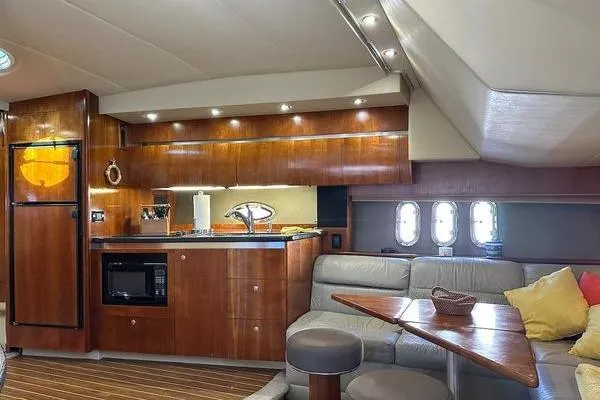  Yacht Photos Pics Luxurious 2005 Cruisers 420 yacht interior with modern kitchen and cozy seating area.