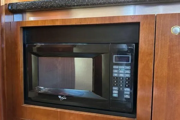  Yacht Photos Pics Built-in microwave in 2005 Cruisers 420 yacht kitchen with wooden cabinetry.