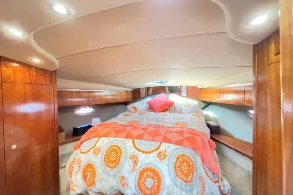  Yacht Photos Pics Luxurious 2005 Cruisers 420 yacht cabin with cozy bedding and elegant wood finishes.