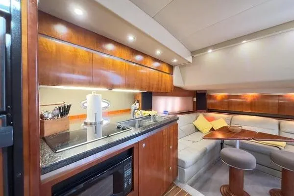  Yacht Photos Pics Luxurious 2005 Cruisers 420 yacht interior with modern kitchen and cozy seating area.